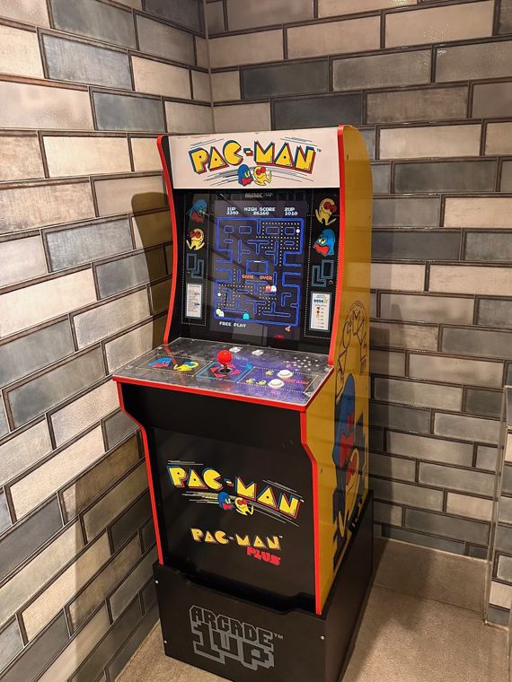 A Pac-Man arcade cabinet standing in a cafe